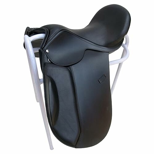 Black dressage saddle on a white stand.