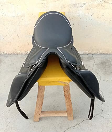 Black horse saddle on a wooden stand